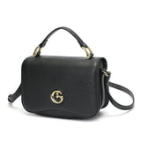 Small black women's handbag with top handle and shoulder strap