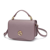 Small women's handbag in mauve color with top handle and shoulder strap