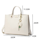 An elegant handbag with a wide cushion, 32 cm wide, in brown or cream color