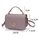Small women's handbag in mauve color with top handle and shoulder strap