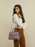 Elegant women's handbag in mauve color with a top handle and practical design