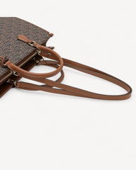 A luxurious bag in coffee and brown with a classic, elegant design and sophisticated, modern touches.