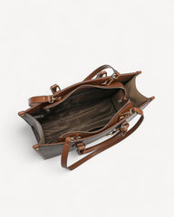 A luxurious bag in coffee and brown with a classic, elegant design and sophisticated, modern touches.